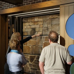 Edward Andrews Homes associate designer Emily Stewart discusses stone options with buyers Hans Joachim and Kristine Lodde, who are building a home in the Estatates at Hedgerow, a new community in East Cobb.Courtesy Edward Andrews Homes.